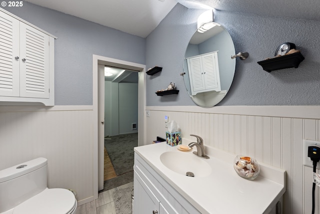 540 Kesling St, Harrisburg, OR 97446 - bathroom with a wainscoted wall, toilet, and vanity