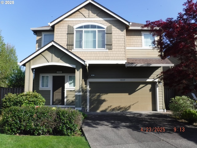 15117 SE Shale Dr, Damascus, OR 97089 - view of front of home featuring an attached garage, driveway, fence, and roof with shingles
