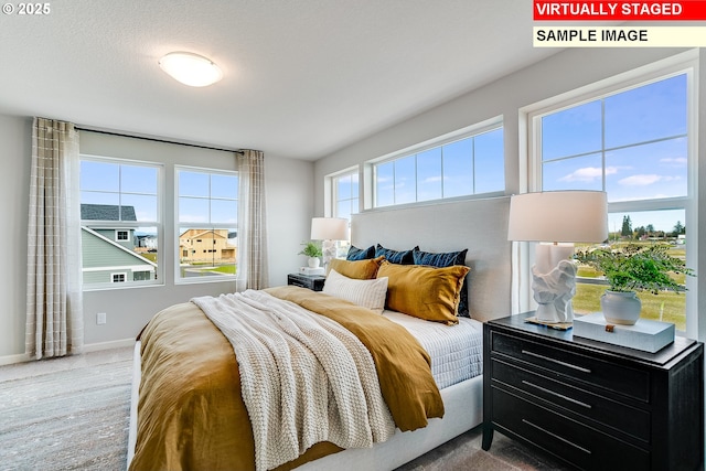 carpeted bedroom featuring baseboards