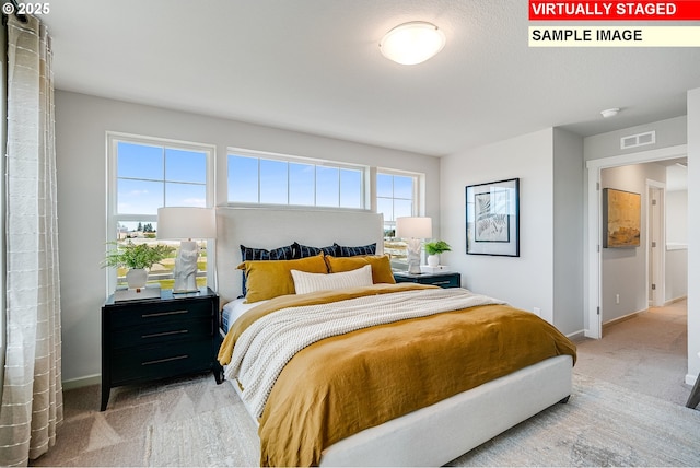 bedroom with carpet floors, baseboards, and visible vents