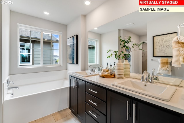 full bath featuring a garden tub, tile patterned flooring, a sink, and a wealth of natural light