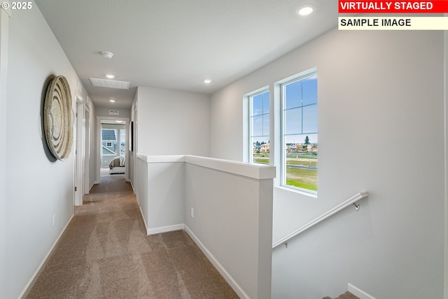 hall with recessed lighting, carpet floors, visible vents, an upstairs landing, and baseboards