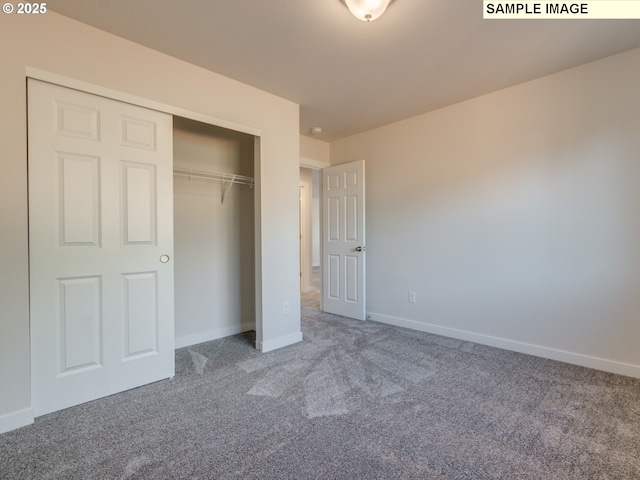 unfurnished bedroom featuring a closet and carpet