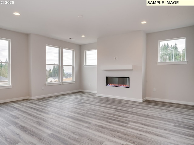 unfurnished living room with light hardwood / wood-style flooring