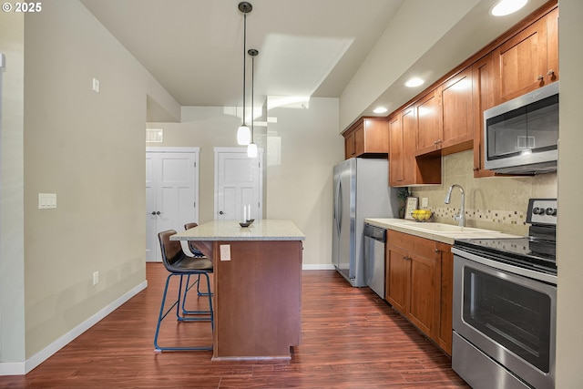 13885 SW Meridian St Unit 135, Beaverton, OR 97005 - kitchen featuring stainless steel appliances, a center island, tasteful backsplash, dark wood-style floors, and recessed lighting