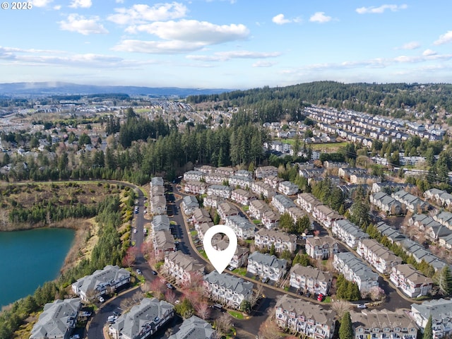 drone / aerial view featuring a residential view and a water view