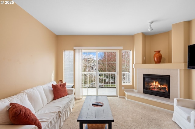 carpeted living area with a fireplace