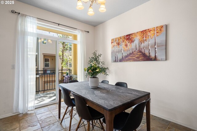 842 NE Rothbury Ave, Hillsboro, OR 97124 - dining space featuring an inviting chandelier, stone tile floors, and baseboards