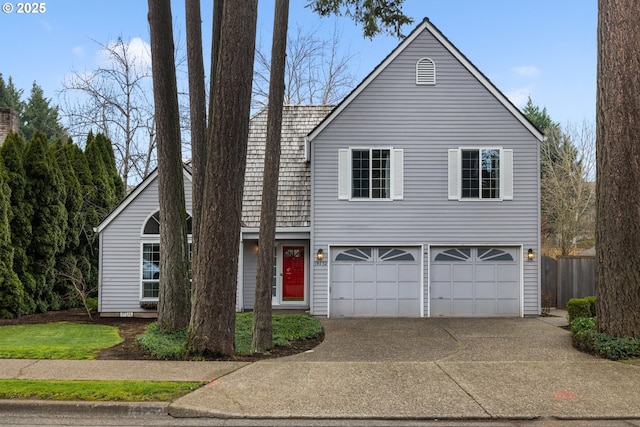 traditional-style house with an attached garage and concrete driveway