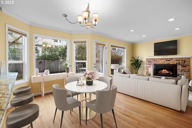 dining room with plenty of natural light, crown molding, and an inviting chandelier