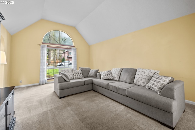 carpeted living area featuring baseboards and vaulted ceiling