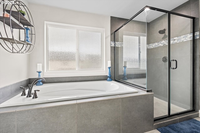 bathroom featuring separate shower and tub