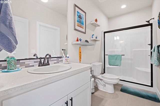 bathroom with vanity, toilet, a shower with shower door, and tile patterned flooring