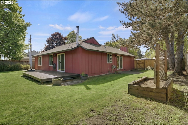 back of property with a lawn, a fenced backyard, board and batten siding, and a wooden deck