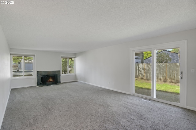 unfurnished living room with baseboards, a fireplace with flush hearth, and a textured ceiling