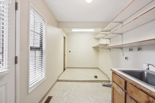 1200 NE Territorial Rd Unit 83, Canby, OR 97013 - laundry area with hookup for a washing machine, a textured ceiling, and baseboards