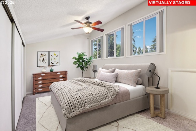 1200 NE Territorial Rd Unit 83, Canby, OR 97013 - carpeted bedroom with a textured ceiling, lofted ceiling, and baseboards