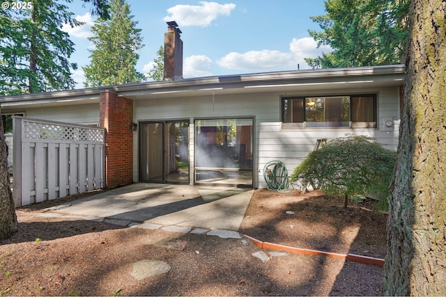 1200 NE Territorial Rd Unit 83, Canby, OR 97013 - back of property featuring a chimney and a patio