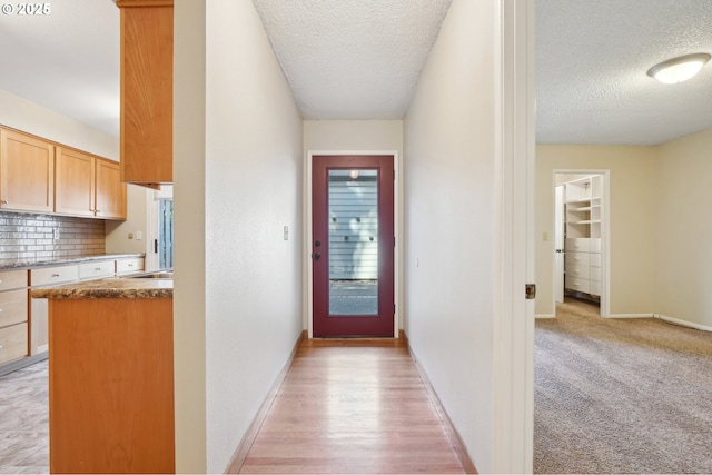 1200 NE Territorial Rd Unit 83, Canby, OR 97013 - corridor featuring a textured ceiling and baseboards
