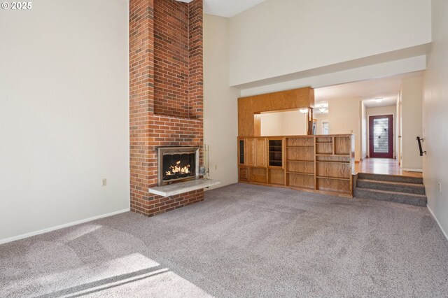 1200 NE Territorial Rd Unit 83, Canby, OR 97013 - unfurnished living room featuring a high ceiling, carpet flooring, a brick fireplace, and baseboards
