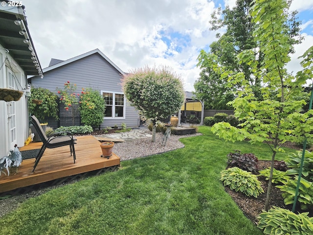 view of green lawn with a deck