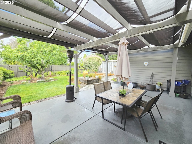 view of patio with a pergola, outdoor dining area, a storage shed, and an outbuilding