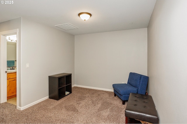 sitting room featuring sink and light colored carpet