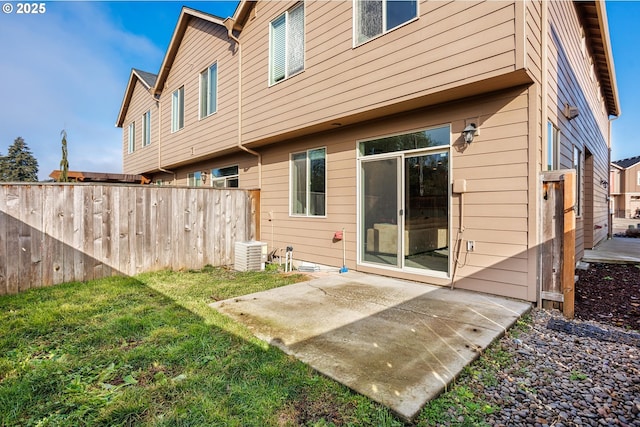 back of house with a patio area and a lawn