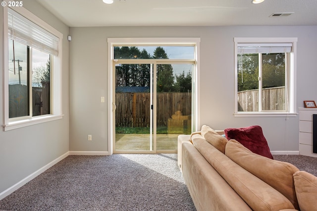 doorway to outside with a healthy amount of sunlight and carpet flooring