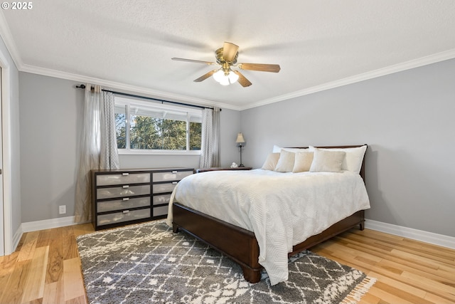 bedroom featuring ceiling fan, crown molding, and hardwood / wood-style flooring