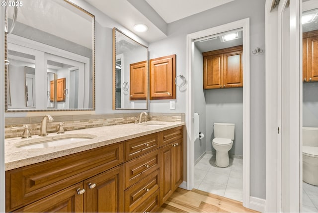 bathroom featuring vanity, toilet, and tile patterned flooring