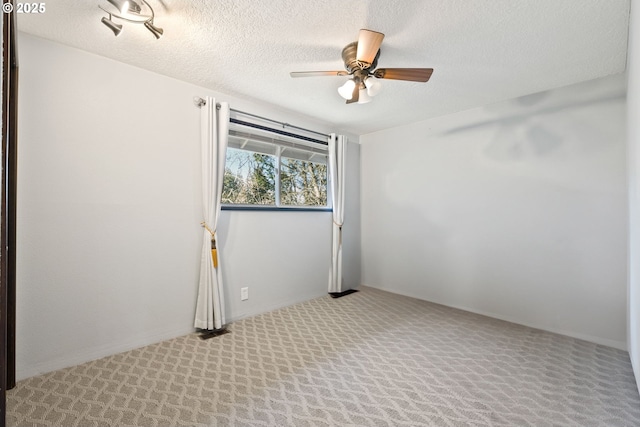 carpeted empty room with a textured ceiling and ceiling fan