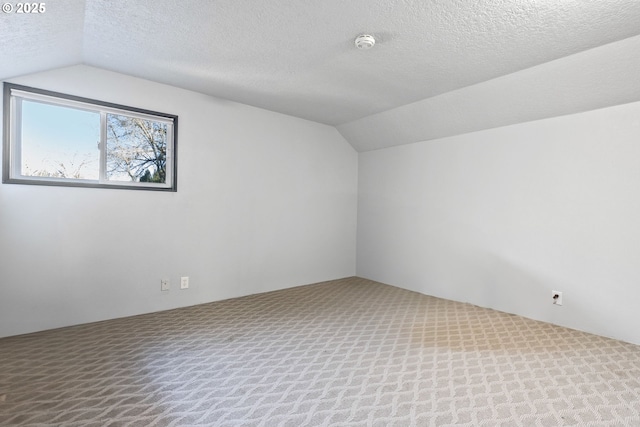 bonus room with a textured ceiling, vaulted ceiling, and carpet floors