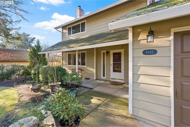 view of exterior entry with a patio