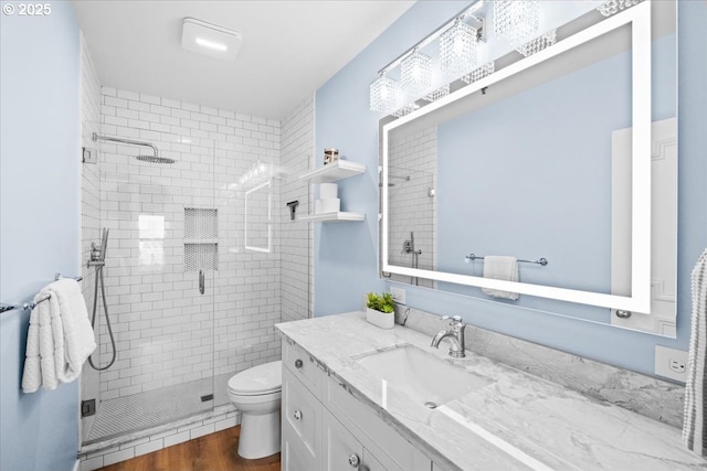 310 NW Uptown Ter Unit 1A, Portland, OR 97210 - full bath featuring vanity, a shower stall, and wood finished floors