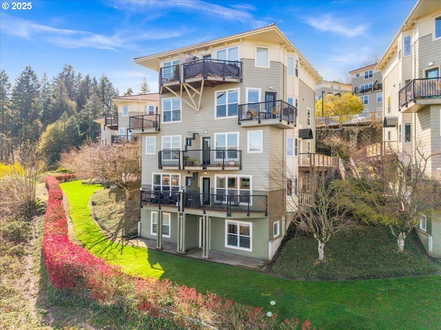 310 NW Uptown Ter Unit 1A, Portland, OR 97210 - rear view of house with a balcony and a lawn