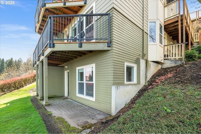 310 NW Uptown Ter Unit 1A, Portland, OR 97210 - view of home's exterior featuring a yard, a balcony, and a patio