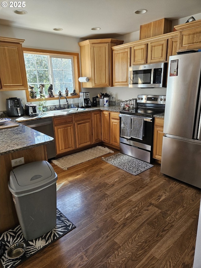 510 NE Yamhill St, Sheridan, OR 97378 - kitchen with dark wood-type flooring, dark stone countertops, stainless steel appliances, and a sink