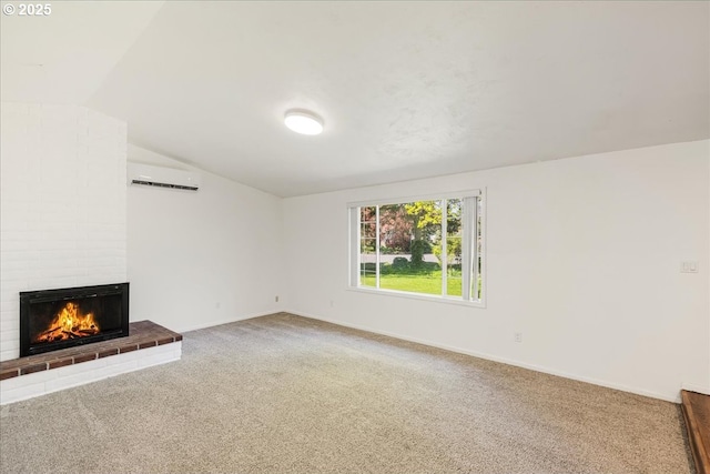 15215 SE 1st St, Vancouver, WA 98684 - unfurnished living room with baseboards, an AC wall unit, vaulted ceiling, carpet floors, and a brick fireplace