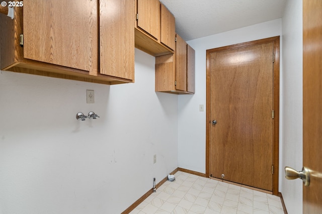 laundry room with cabinet space, hookup for a gas dryer, baseboards, and hookup for a washing machine