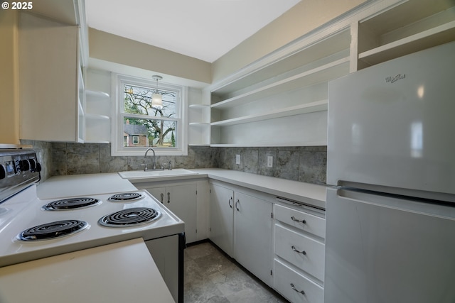 kitchen with white appliances, a sink, light countertops, open shelves, and tasteful backsplash