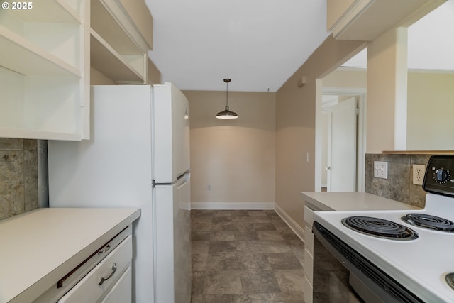 kitchen featuring pendant lighting, light countertops, backsplash, freestanding refrigerator, and range with electric cooktop