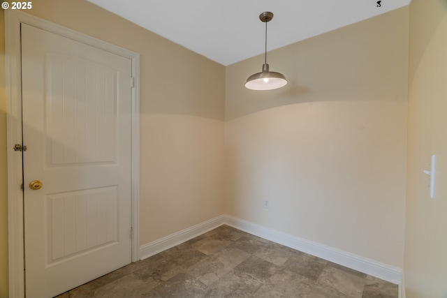 unfurnished dining area with baseboards