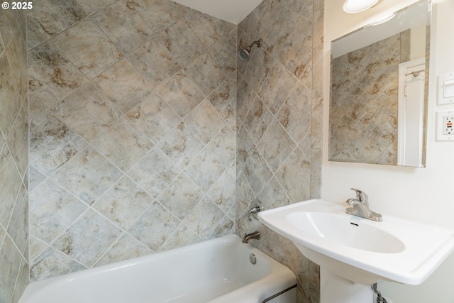 full bath featuring a sink and bathing tub / shower combination