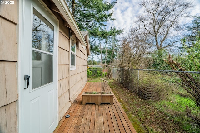 wooden terrace featuring fence