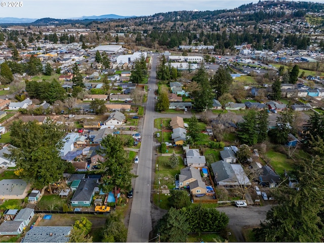 drone / aerial view featuring a residential view and a mountain view