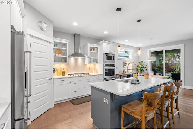 10603 NE 92nd Ave, Vancouver, WA 98662 - kitchen with wall chimney range hood, a sink, stainless steel appliances, a kitchen bar, and white cabinets