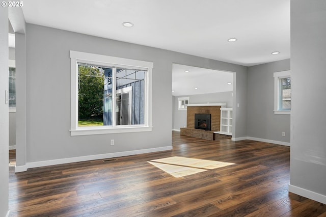 220 Adams Ave, Silverton, OR 97381 - unfurnished living room with dark wood-style flooring, a fireplace, recessed lighting, and baseboards