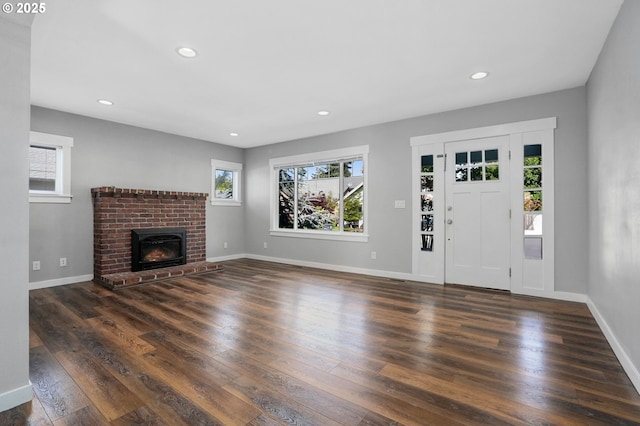 220 Adams Ave, Silverton, OR 97381 - unfurnished living room with wood finished floors, recessed lighting, baseboards, and a brick fireplace