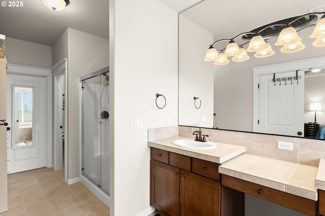 bathroom featuring vanity, decorative backsplash, tile patterned floors, and a shower stall